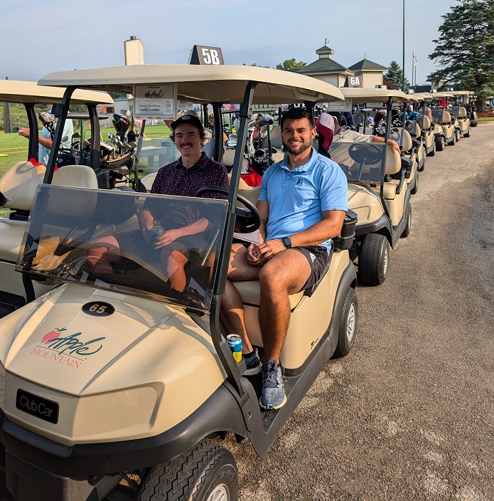 two golfers in their cart ready to start golfing